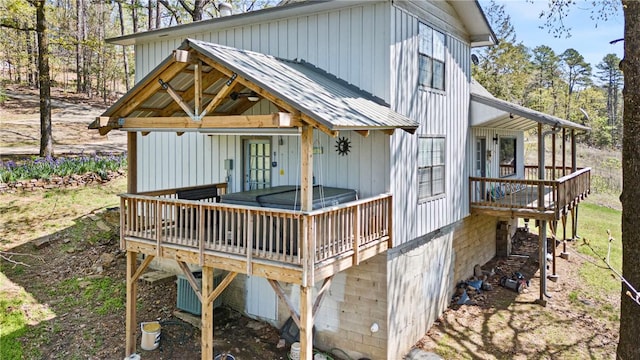 rear view of property with metal roof and a deck