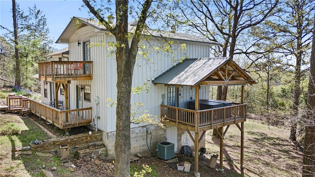 rear view of property featuring a wooden deck
