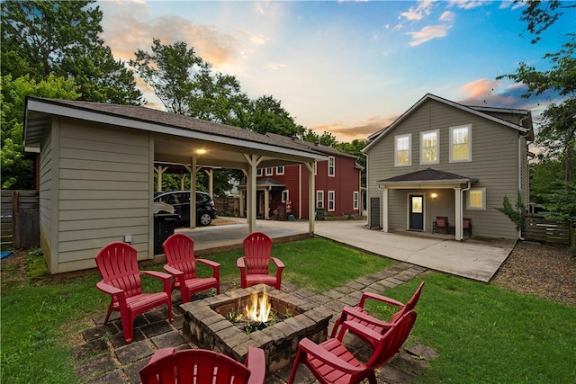 328 Martin Luther King Jr Blvd, Fayetteville, AR 72701 - back of house at dusk featuring a fire pit, a lawn, and a patio area