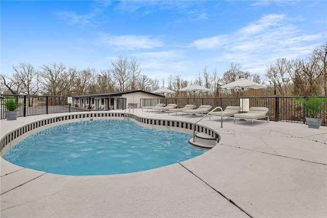 community pool featuring a patio and fence