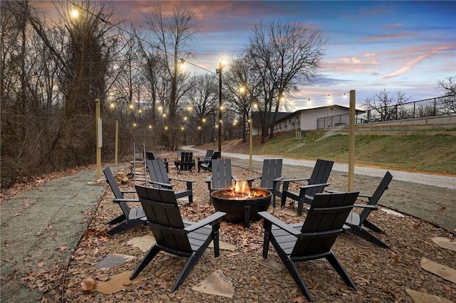 patio terrace at dusk featuring a fire pit