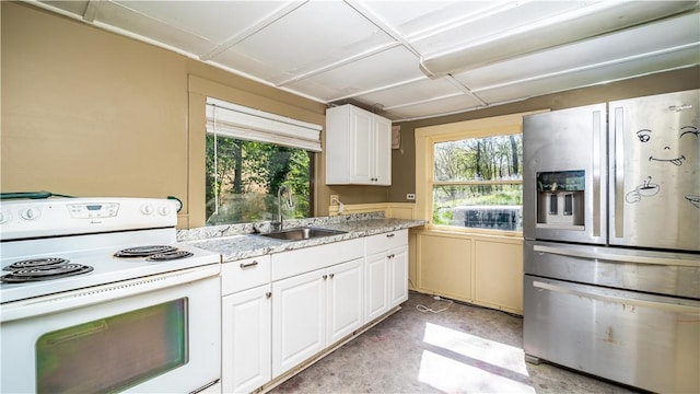 kitchen with white electric range, a healthy amount of sunlight, a sink, and stainless steel fridge with ice dispenser