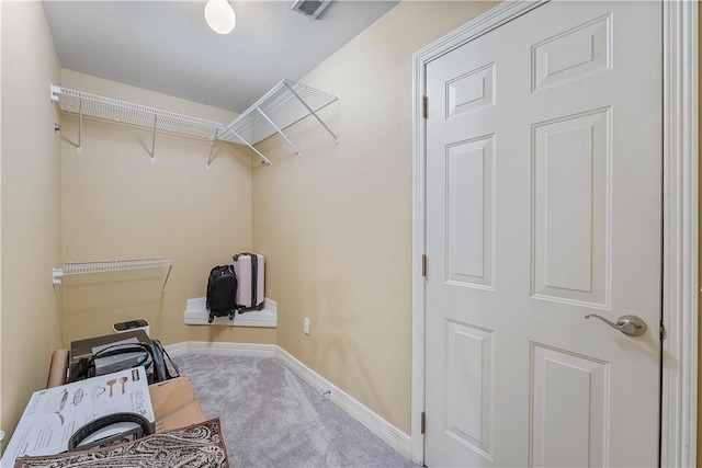 walk in closet featuring carpet