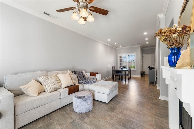 living area with a ceiling fan, ornamental molding, visible vents, recessed lighting, and baseboards