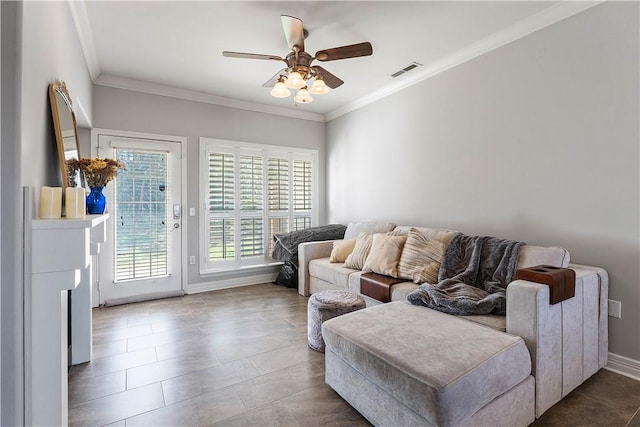 sitting room with visible vents, baseboards, ceiling fan, crown molding, and tile patterned floors