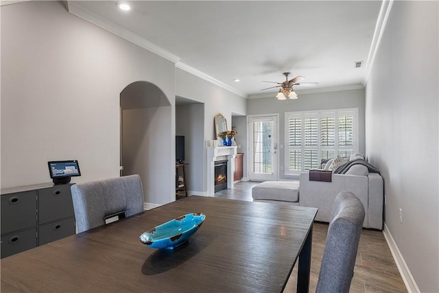 dining room featuring baseboards, a lit fireplace, recessed lighting, ceiling fan, and wood finished floors