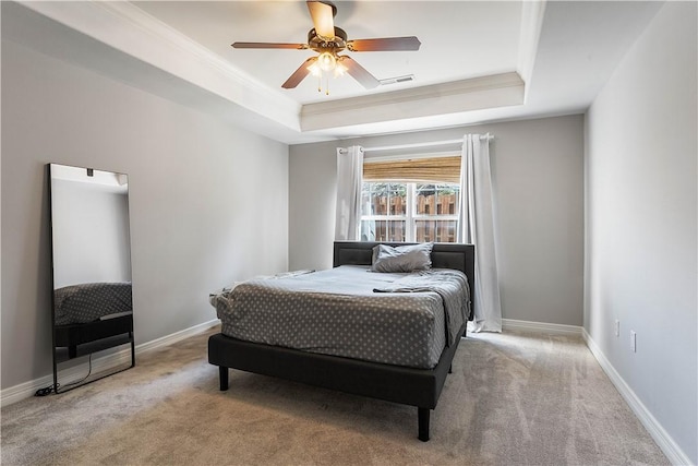 bedroom featuring crown molding, visible vents, a tray ceiling, and carpet flooring