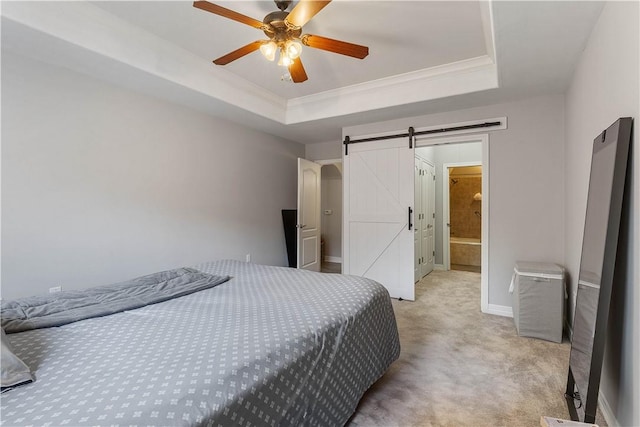 bedroom with baseboards, light carpet, crown molding, a barn door, and a raised ceiling