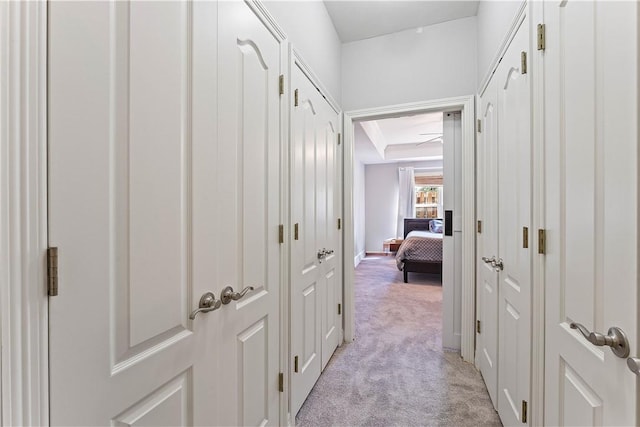 corridor with light colored carpet