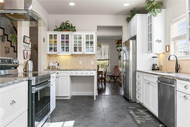 2104 Delwhite Dr, Bentonville, AR 72712 - kitchen with tasteful backsplash, wall chimney range hood, white cabinets, appliances with stainless steel finishes, and a sink