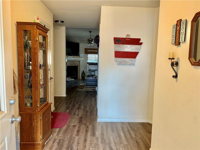 hall with baseboards and dark wood-style floors