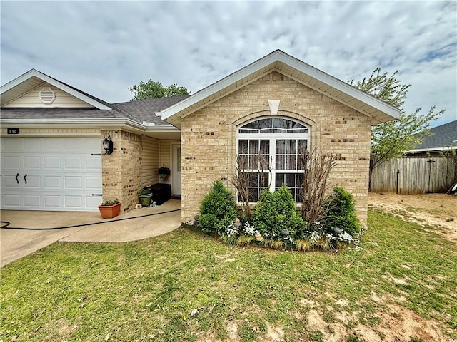 ranch-style home featuring a front yard, a garage, fence, brick siding, and driveway