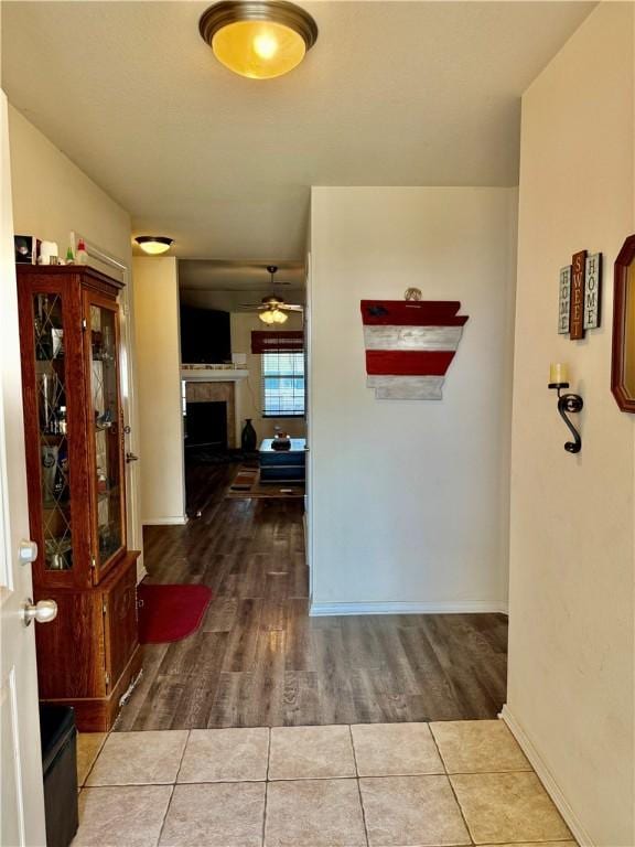 hallway featuring wood finished floors and baseboards