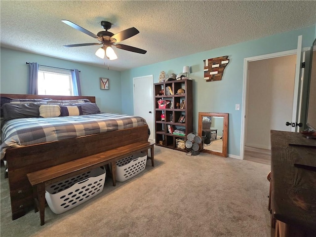carpeted bedroom featuring a textured ceiling and ceiling fan