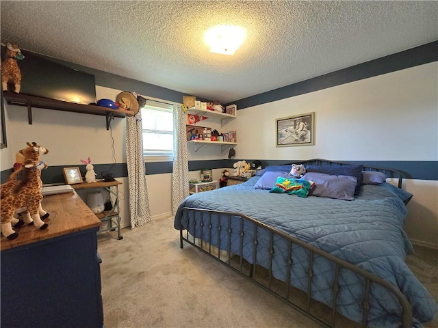 bedroom with light colored carpet and a textured ceiling