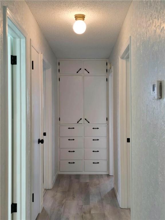corridor with a textured ceiling