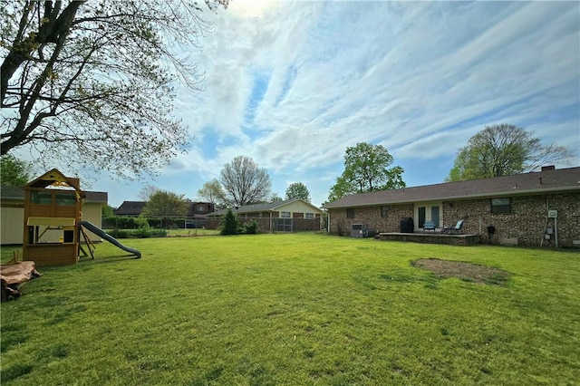 view of yard with fence and a playground