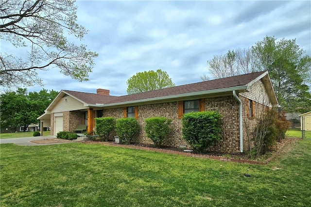ranch-style home with brick siding, a front lawn, an attached garage, and driveway