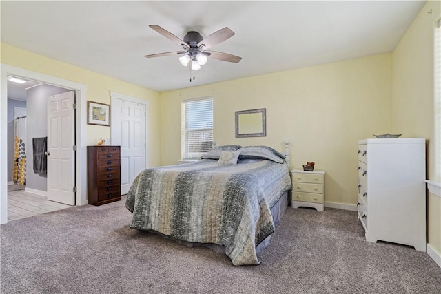 carpeted bedroom featuring ceiling fan and baseboards