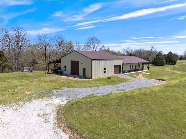 view of pole building featuring a yard and gravel driveway