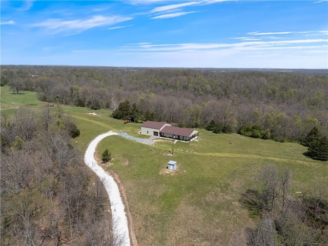 drone / aerial view with a view of trees and a rural view