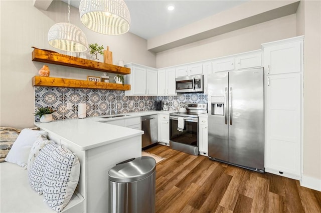 kitchen featuring open shelves, a sink, appliances with stainless steel finishes, a peninsula, and white cabinetry