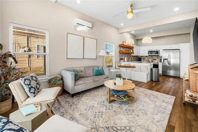 living room featuring dark wood-style flooring, ceiling fan, recessed lighting, and a wall mounted air conditioner