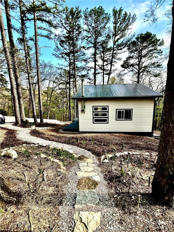 view of side of property with metal roof