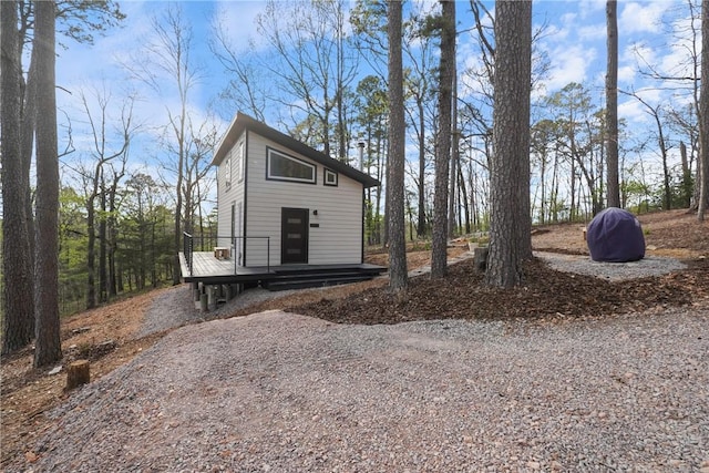 view of property exterior featuring a wooden deck