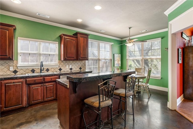 3512 Hamm Ln, Springdale, AR 72762 - kitchen with a kitchen breakfast bar, a sink, a kitchen island, decorative backsplash, and ornamental molding