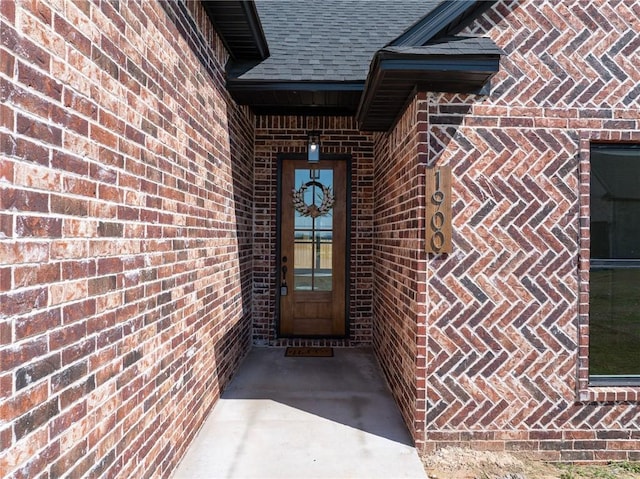 1900 Yellowstone Dr, Barling, AR 72923 - doorway to property featuring brick siding and roof with shingles