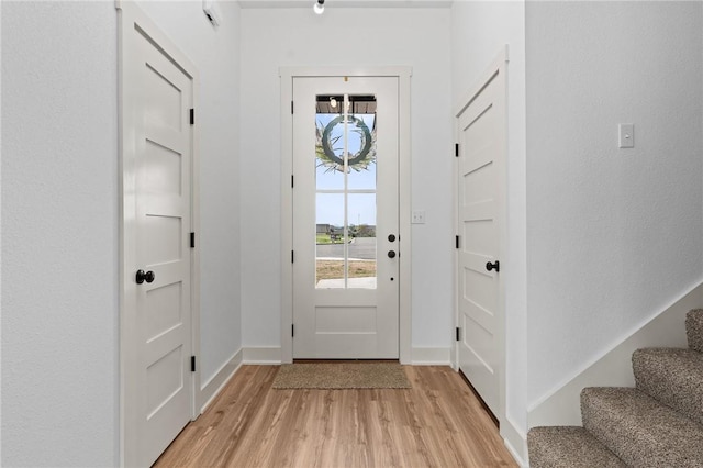 1900 Yellowstone Dr, Barling, AR 72923 - doorway to outside featuring light wood-style flooring, plenty of natural light, baseboards, and stairs