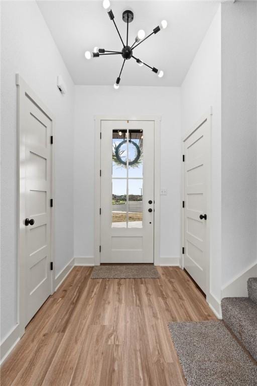 1900 Yellowstone Dr, Barling, AR 72923 - entryway featuring light wood-style floors, stairway, a notable chandelier, and baseboards