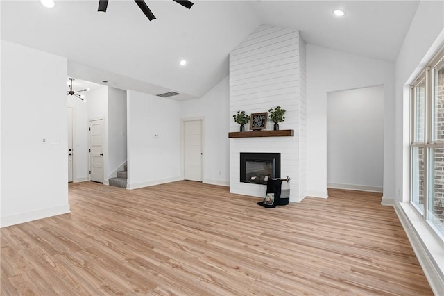 1900 Yellowstone Dr, Barling, AR 72923 - unfurnished living room featuring a large fireplace, ceiling fan, stairway, and a healthy amount of sunlight
