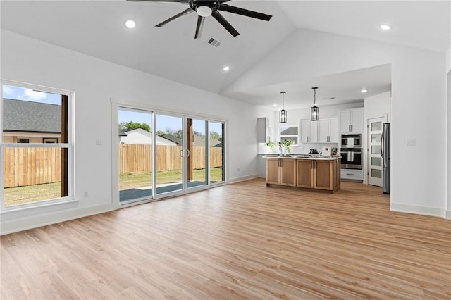 1900 Yellowstone Dr, Barling, AR 72923 - living room featuring baseboards, a ceiling fan, light wood-style floors, visible vents, and high vaulted ceiling