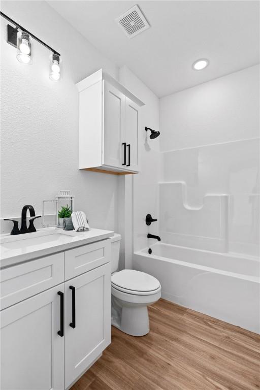 1900 Yellowstone Dr, Barling, AR 72923 - full bathroom featuring visible vents, toilet, bathtub / shower combination, vanity, and wood finished floors