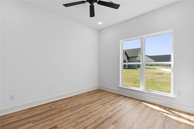 1900 Yellowstone Dr, Barling, AR 72923 - empty room with light wood finished floors, baseboards, a ceiling fan, and a healthy amount of sunlight