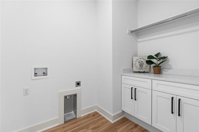 1900 Yellowstone Dr, Barling, AR 72923 - laundry room with hookup for an electric dryer, light wood-type flooring, baseboards, washer hookup, and cabinet space