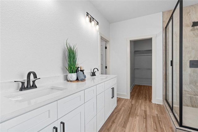 1900 Yellowstone Dr, Barling, AR 72923 - full bath featuring a shower stall, wood finished floors, a sink, and a spacious closet