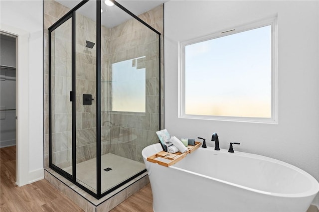 1900 Yellowstone Dr, Barling, AR 72923 - full bathroom featuring a freestanding tub, a stall shower, and wood finished floors