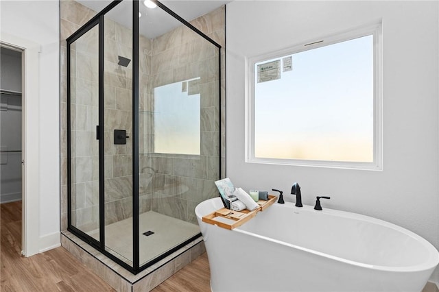 1900 Yellowstone Dr, Barling, AR 72923 - full bathroom featuring a shower stall, a soaking tub, and wood finished floors