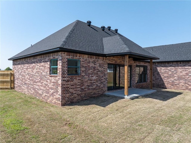 1900 Yellowstone Dr, Barling, AR 72923 - back of house featuring a patio area, a yard, fence, brick siding, and roof with shingles