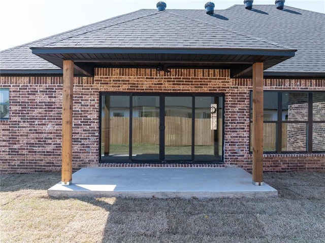 1900 Yellowstone Dr, Barling, AR 72923 - entrance to property with a shingled roof, a patio area, and brick siding