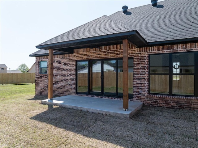 1900 Yellowstone Dr, Barling, AR 72923 - back of house featuring brick siding, fence, a shingled roof, and a patio area