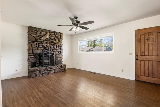 unfurnished living room with baseboards, a ceiling fan, wood finished floors, and a fireplace