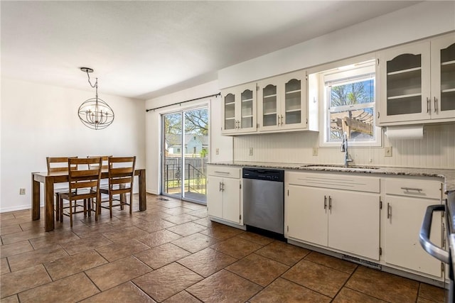kitchen featuring tasteful backsplash, dishwasher, white cabinetry, and a sink