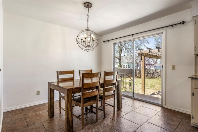 dining space with a chandelier and baseboards