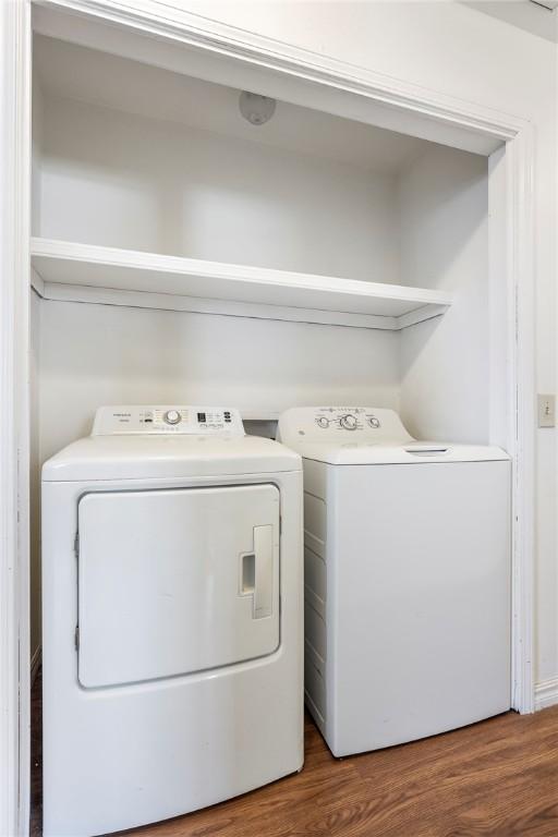 washroom featuring washing machine and clothes dryer and wood finished floors