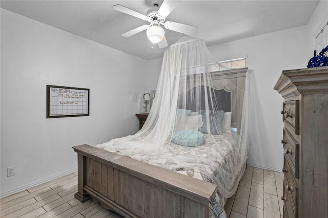 bedroom featuring baseboards, ceiling fan, and wood finish floors