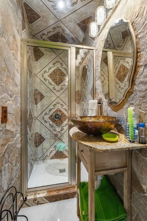 full bathroom with vanity and a stall shower
